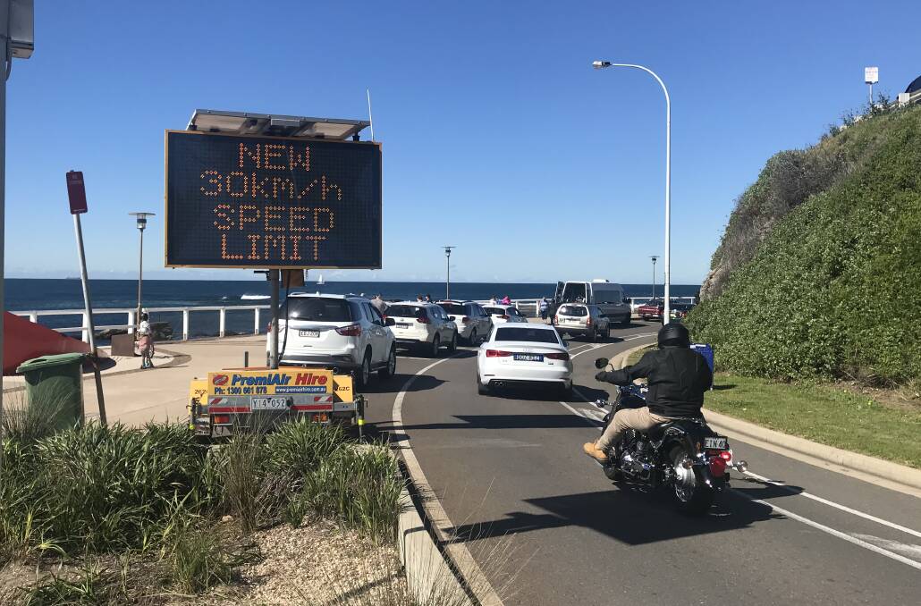 CHANGE: Motorists pass an electronic message board on Shortland Esplanade on Monday warning of the upcoming speed-limit reduction. 