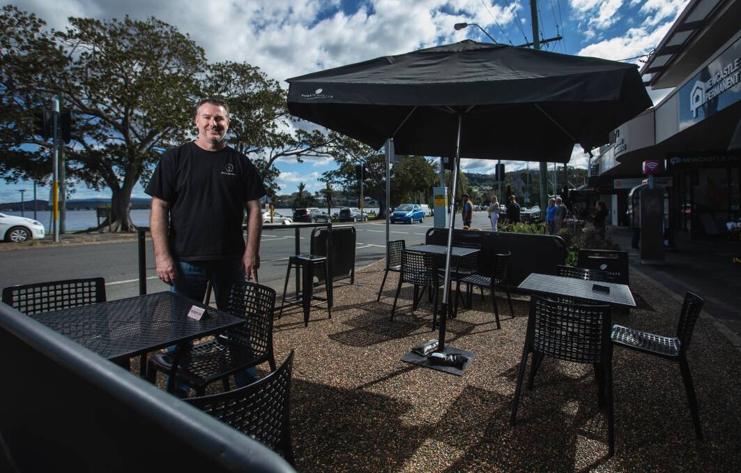 GRIN AND BEAR IT: Aaryn Algie outside his Warners Bay cafe Hippo Espresso last year. He believes the government had little choice but to extend the lockdown. Picture: Marina Neil