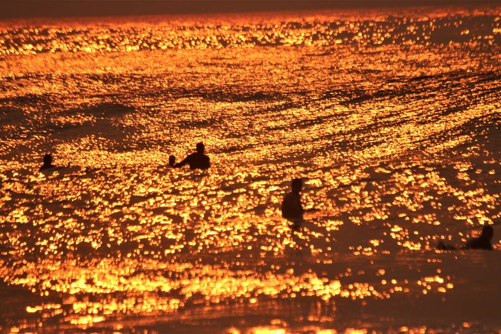 DAWN: Sunrise surfers waiting for a wave. Picture: Dave Anderson