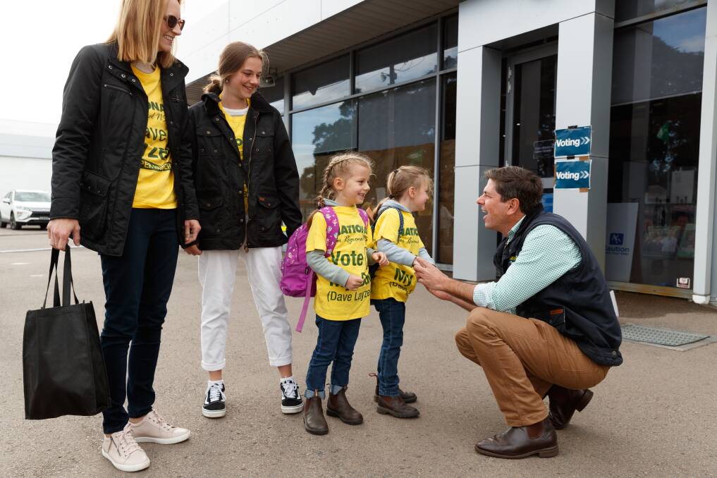 MINI-SUPPORTERS: David Layzell greeting his wife Rachel and daughters Mia, Indie and Ashley at the Singleton pre-polling booth on Friday. 