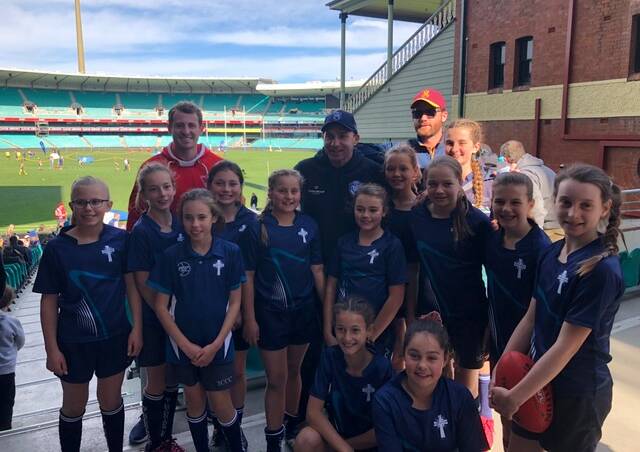 MEET AND GREET: The Year 5/6 girls from St Catherine’s Catholic College Singleton with Swans legend Paul Kelly. 