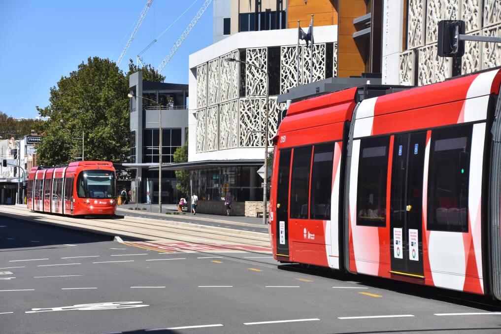 STEADY RUNNING: Two trams ease through a section of the light rail line where cracks have been found in the tracks. Transport for NSW has imposed a 10km/h speed limit on parts of the 2.7-kilometre line. Picture: Max McKinney