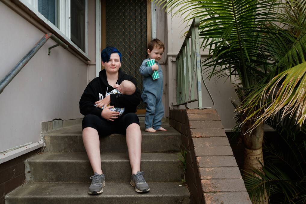 SCAMMED: Kayla Steadman, 19, sitting on the front steps of her mum's home with her sons Donovan and Logan. Picture: Max Mason-Hubers
