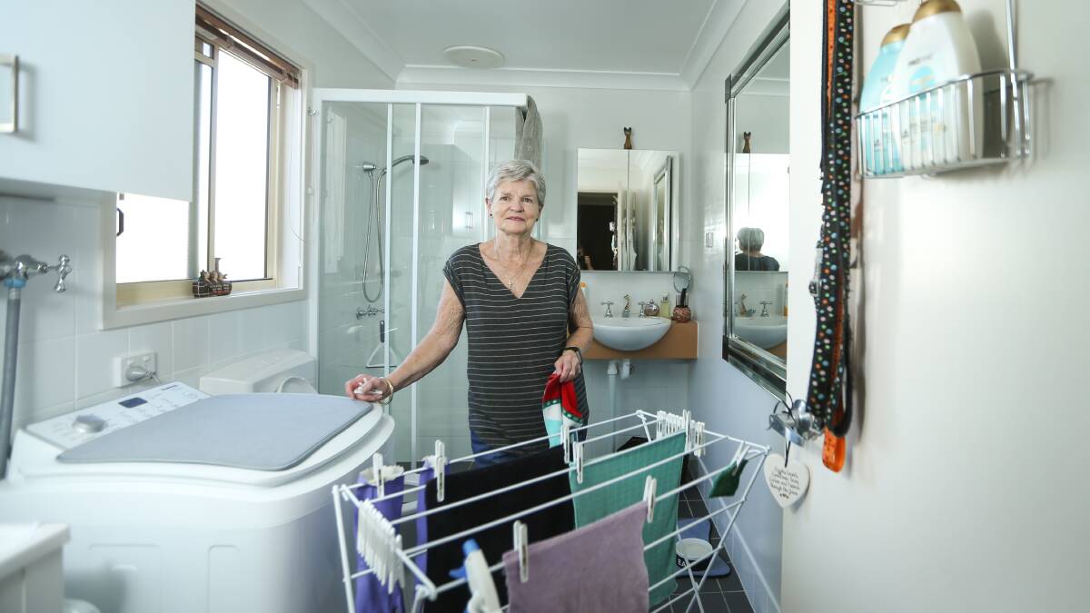 FINALLY: Mayfield resident Deral Black in her newly-repaired bathroom after waiting four months for the work to be completed. Picture: Marina Neil