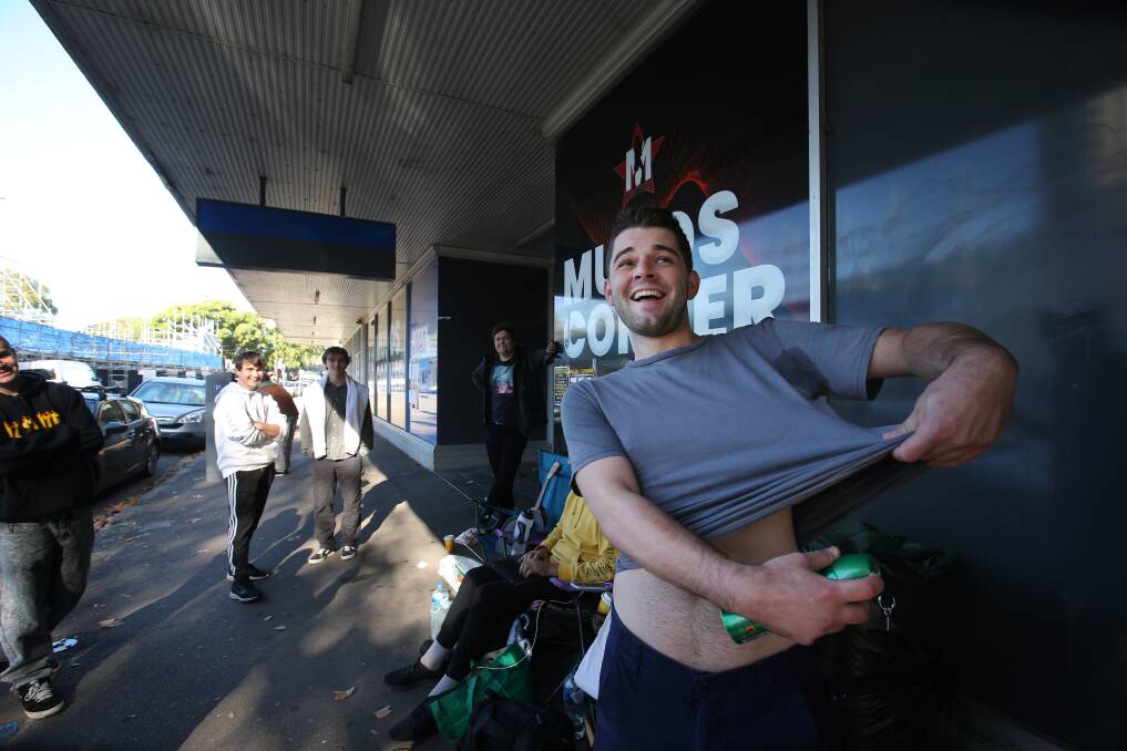 Pat Reilly of Jesmond, enjoys a laugh while spraying some deodorant under his arm after waiting in the line since 7am the day before the 2023 Musos Corner 'May the Fourth' sale. Picture by Simone De Peak