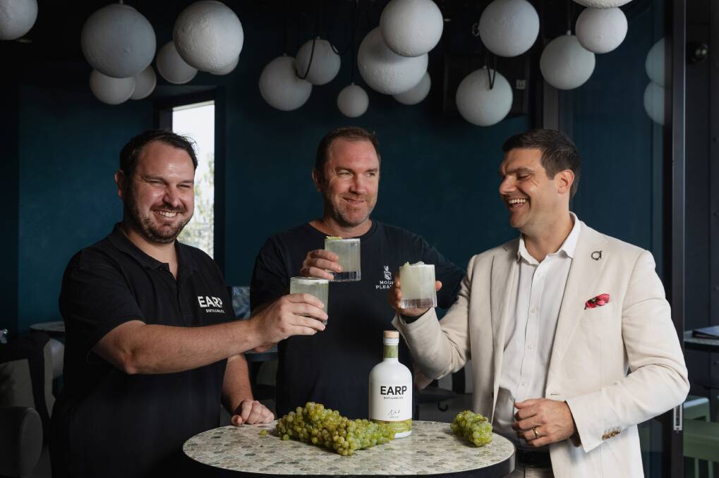 Earp Distillery venue manager Mitch Luke and Mount Pleasant winemaker Adrian Sparks take a sip of the new '2024 Lovedale Smash' cocktail made from Earp No. 8 gin and premium Lovedale semillon grape juice with QT Newcastle general manager Michael Stamboulidis. Picture by Marina Neil