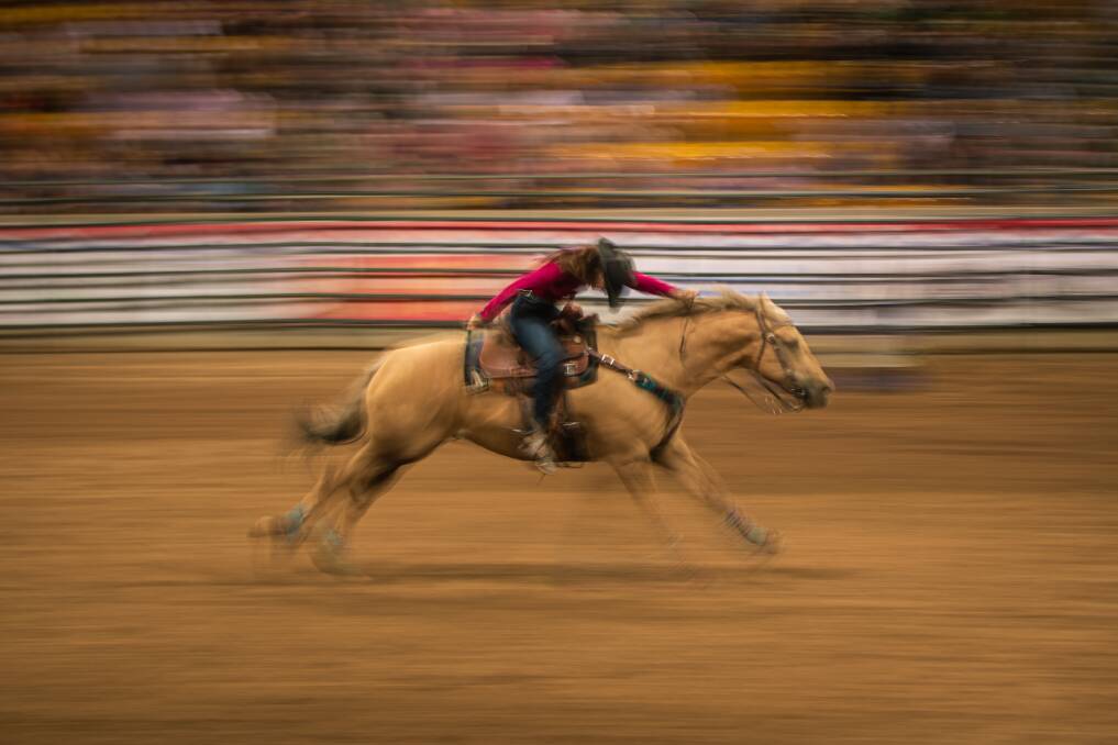 FULL GALLOP: A barrel race rider races home in the last leg of the course at AELEC arena.