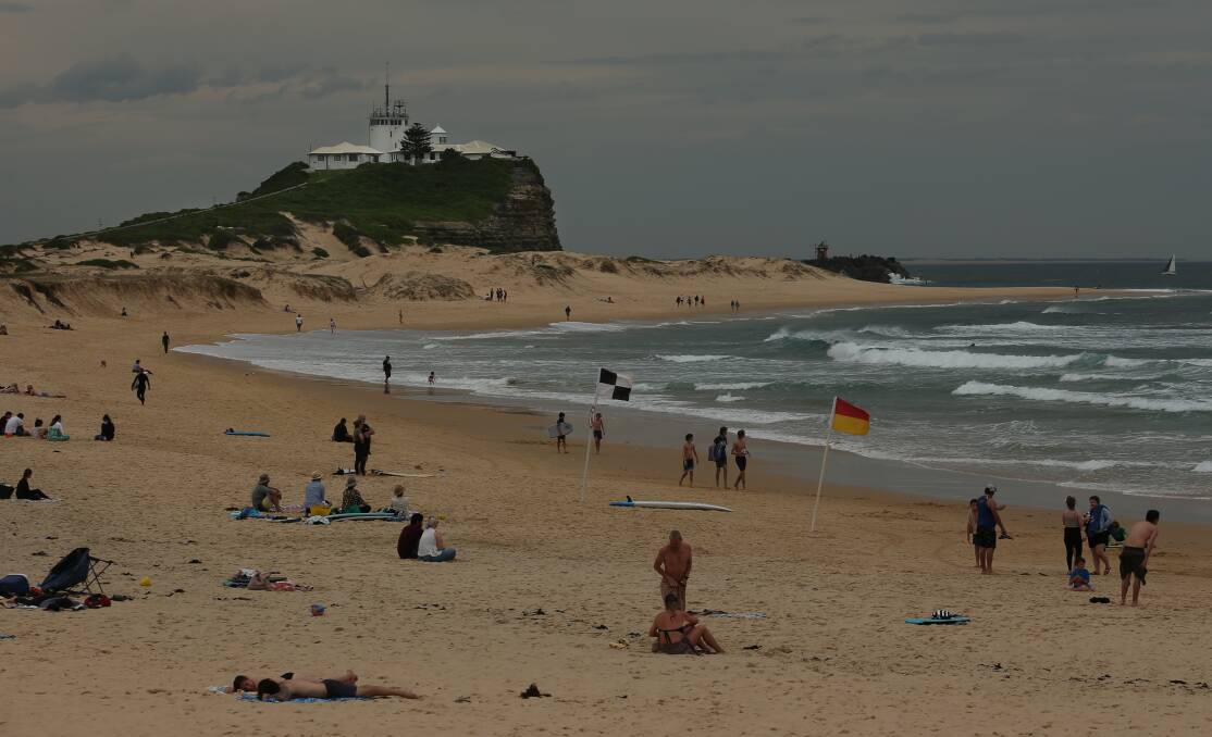 Beachgoers made for Nobbys and the Newcastle Foreshore on Saturday despite overcast and windy conditions. Picture: Simone De Peak