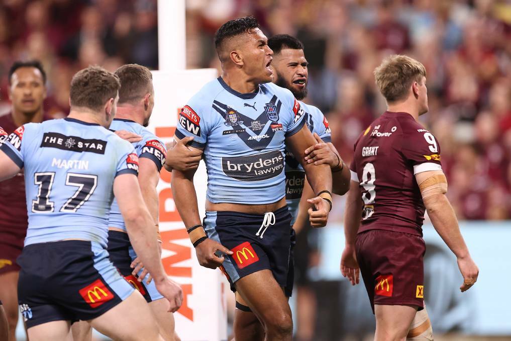 UP IN THE AIR: Knights star Daniel Saifiti celebrates his first Origin try on June 9. 
