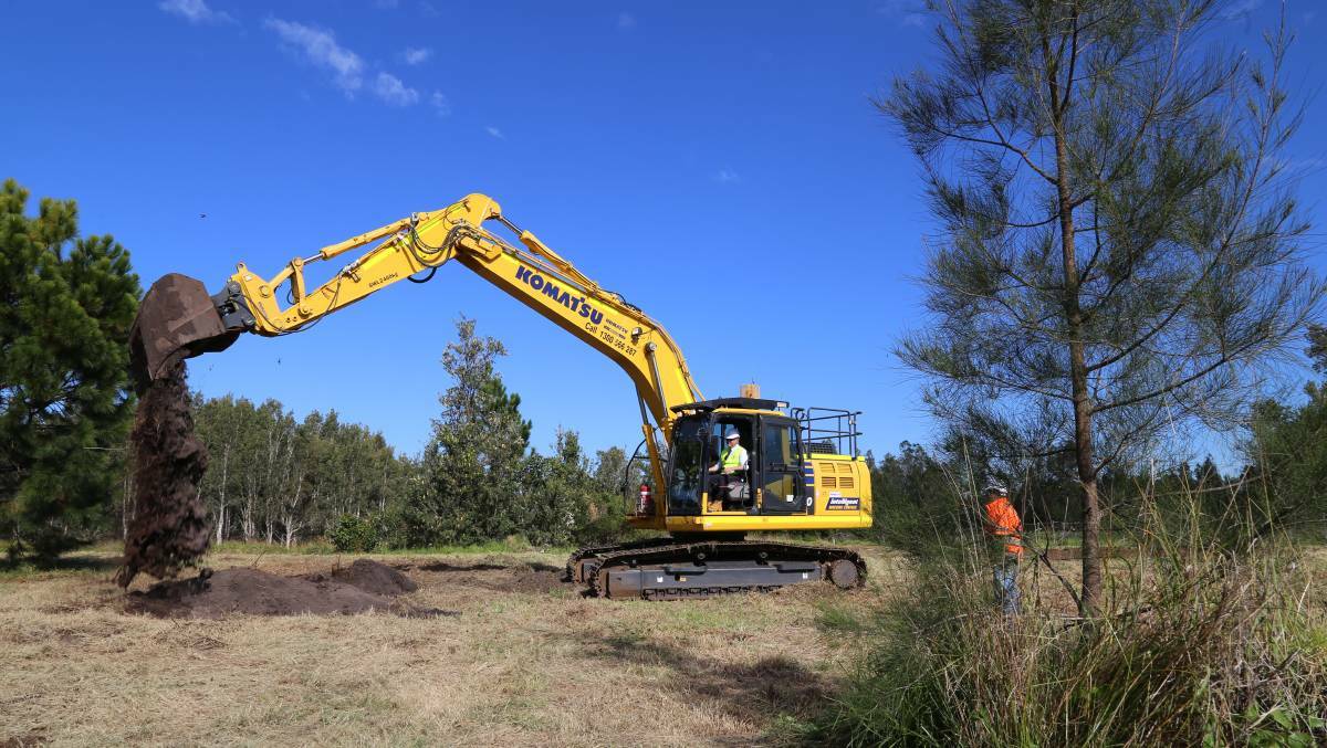 SAFETY FIRST: NSW Deputy Premier John Barilaro turning the first sod excavator style at Williamtown's Astra Aerolab site. Newcastle Airport has signed with BAE Systems Australia to deliver the high-tech hub at Williamtown.