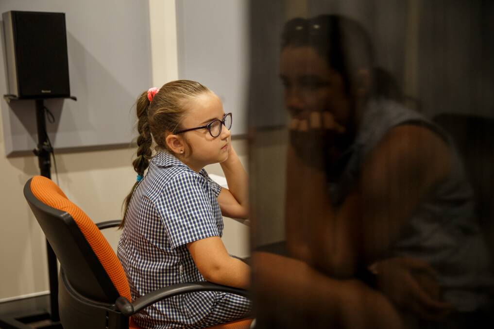 Abbi Keating, aged 8, listening intently during a hearing assessment at SCIC in Newcastle. Picture: Max Mason-Hubers, Newcastle Herald.