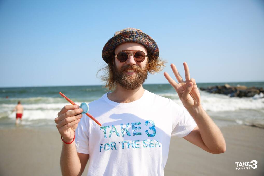 Volunteer Jack Farley collects single-use plastics from the beach for Take 3 for the Sea; an ocean conservation project that grew from the Central Coast to the whole world.