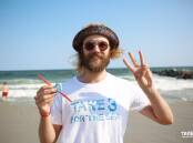 Volunteer Jack Farley collects single-use plastics from the beach for Take 3 for the Sea; an ocean conservation project that grew from the Central Coast to the whole world.