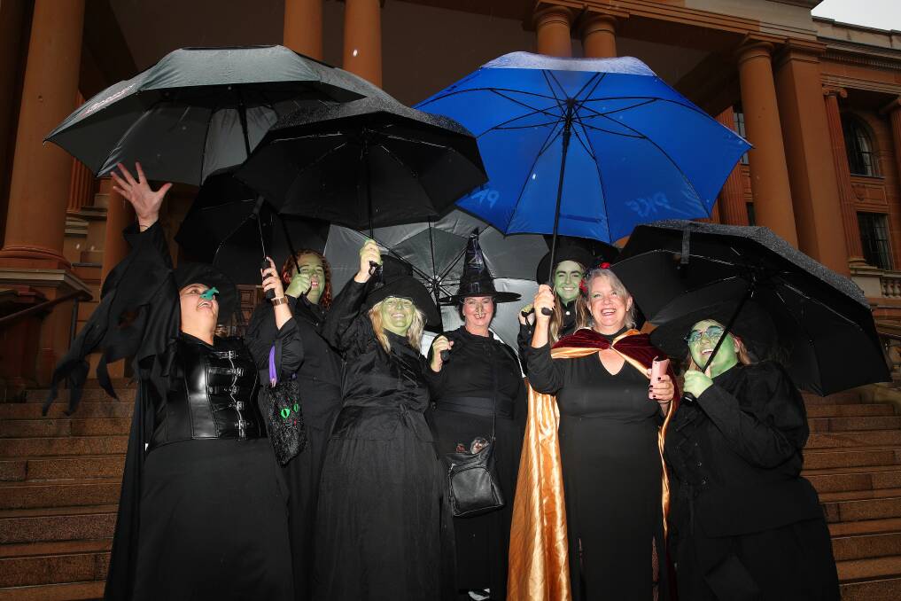 A group of witches brave the weekend's wet weather on a costumed scavenger hunt in Newcastle. Picture by Peter Lorimer