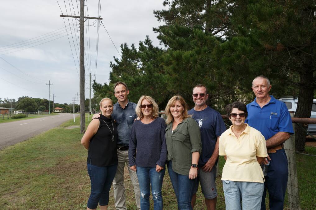 LONG FIGHT: Williamtown residents Sue Walker, Rhianna Gorfine, Cain Gorfine Kim Smith, Gavin Smith, Ann Clout and Lindsay Clout laughing together after a group photo at the Clout family's business in Fullerton Cove. Photo: Max Mason-Hubers