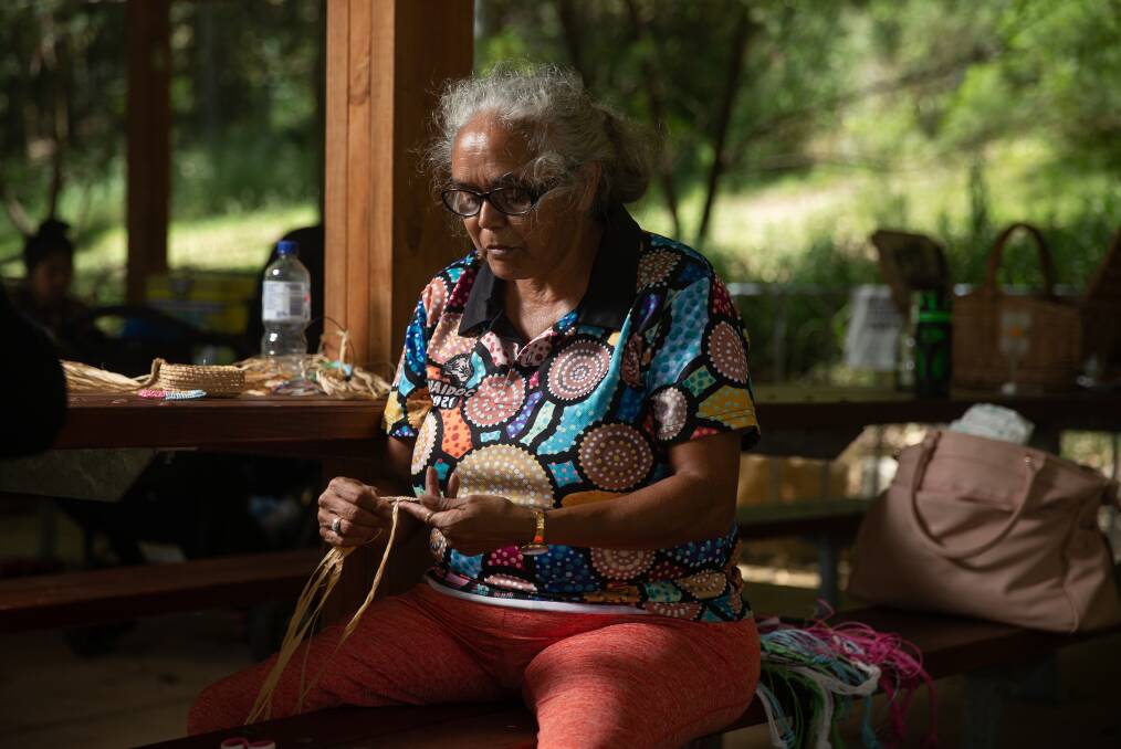 Aunty D teaching people how to weave making some bracelets and other items at the Picnic in the Park at Richley Reserve on January 26. Picture: Marina Neil