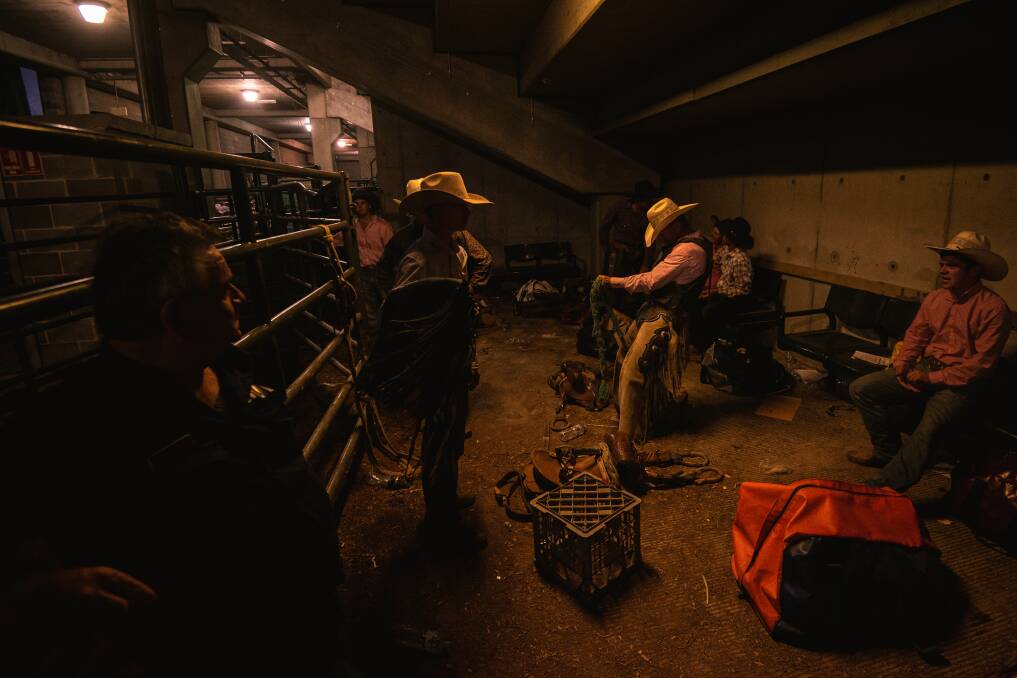 UNDER THE STANDS: Saddle bronc riders prepare for their event at the AELEC arena at Tamworth. Pictures: Simon McCarthy