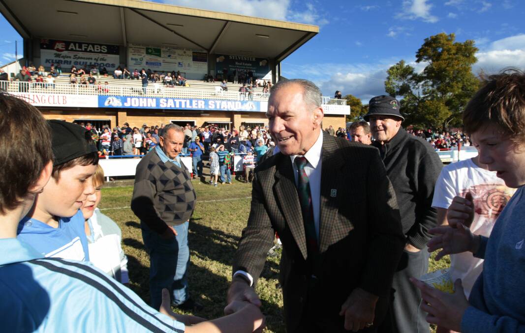 John Sattler greeting young fans at the official unveiling of the grand stand named in his honour at Kurri Kurri Sportsground in 2012. Picture by Peter Stoop