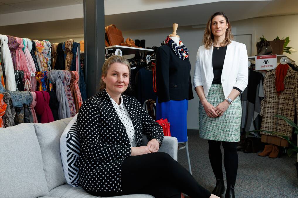 Heidi Adnum, left, and Amba Nalbanthof in the Broadmeadow showroom of Dress For Success. The charity is appealing for $75,000 to keep its operations going in Newcastle.
