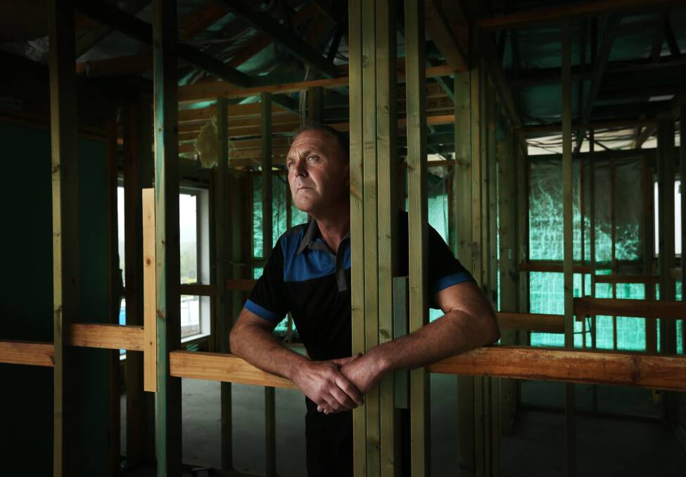 Mick Smith at his partially-built Privium home at Raymond Terrace. Picture: Marina Neil