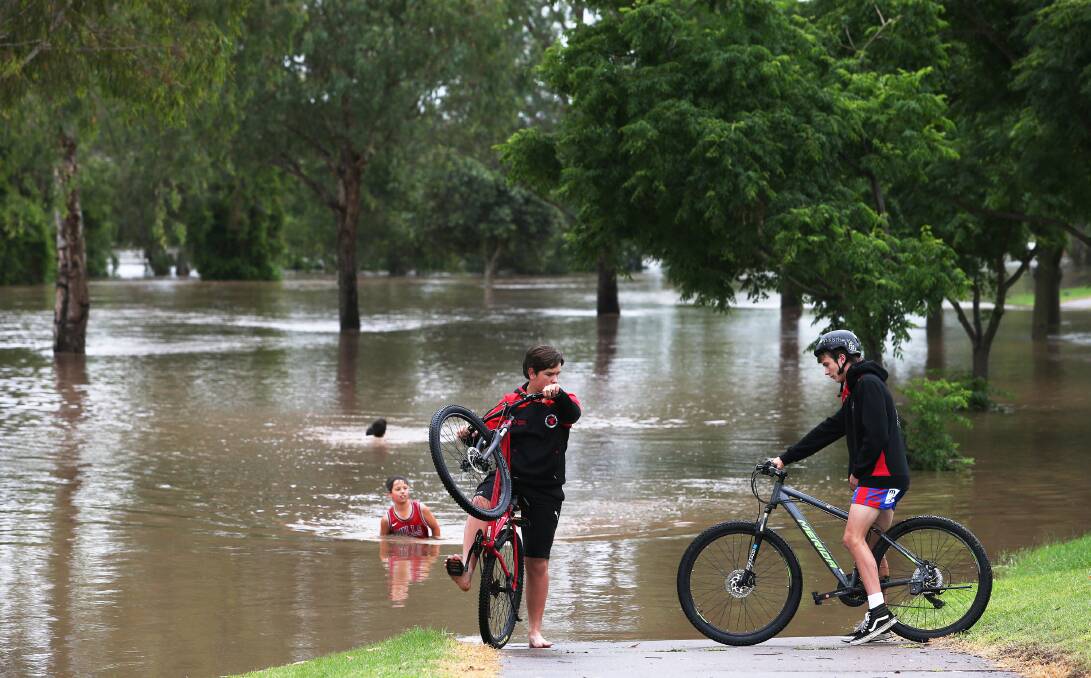The Hunter River bursts it banks at Singleton, where waters are expected to peak - and potentially exceed major flood levels - into Sunday. Picture: Peter Lorimer