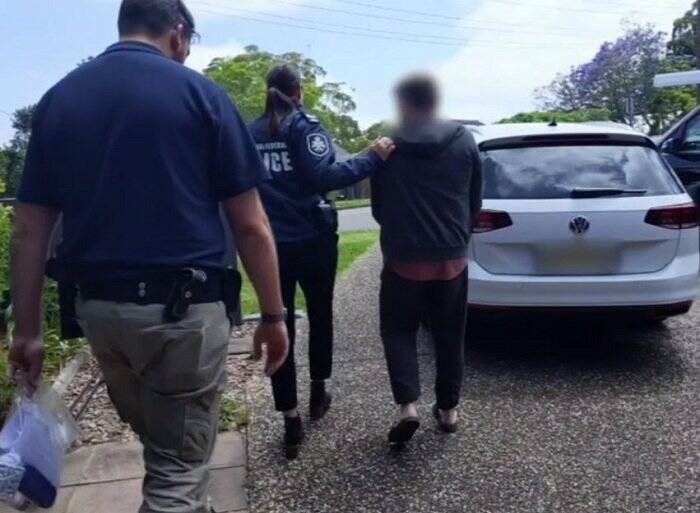 Australian Federal Police arrest a 54-year-old man at New Lambton Heights on Friday. Picture: AFP