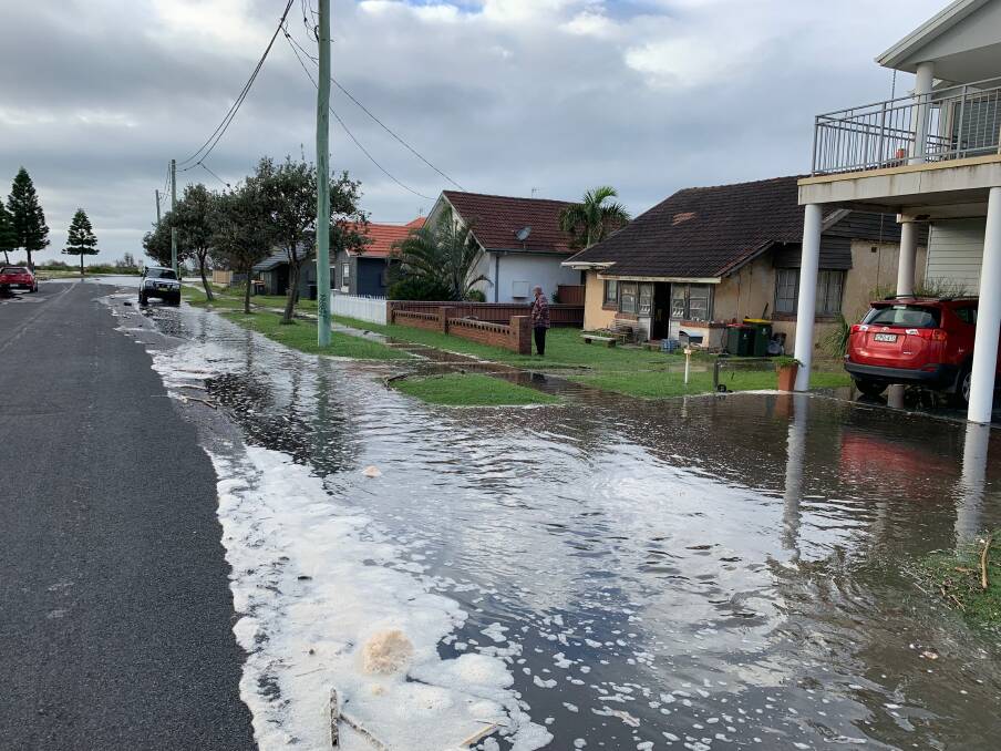 Scenes of the water at its peak on Saturday morning on Meredith Street at Stockton. Picture: John Hunter