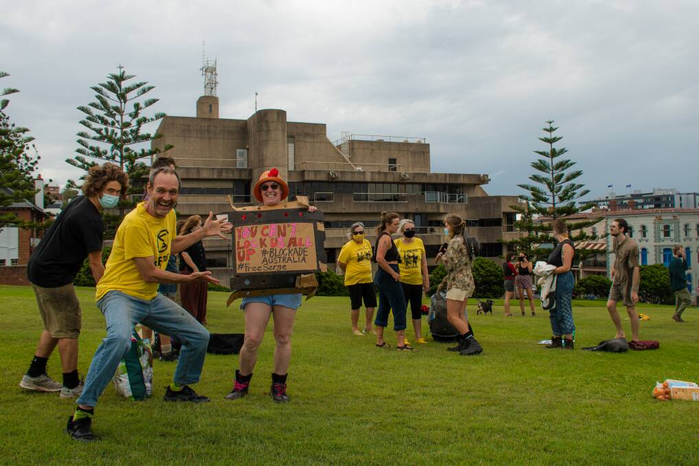 SOLIDARITY: Ross Brown (left) gathered with protesters at Fletcher Park in Newcastle on Wednesday afternoon to show support for Eric Serge Hubert, jailed over an illegal protest disrupting Hunter coal rail lines earlier this month. Picture: Simon McCarthy