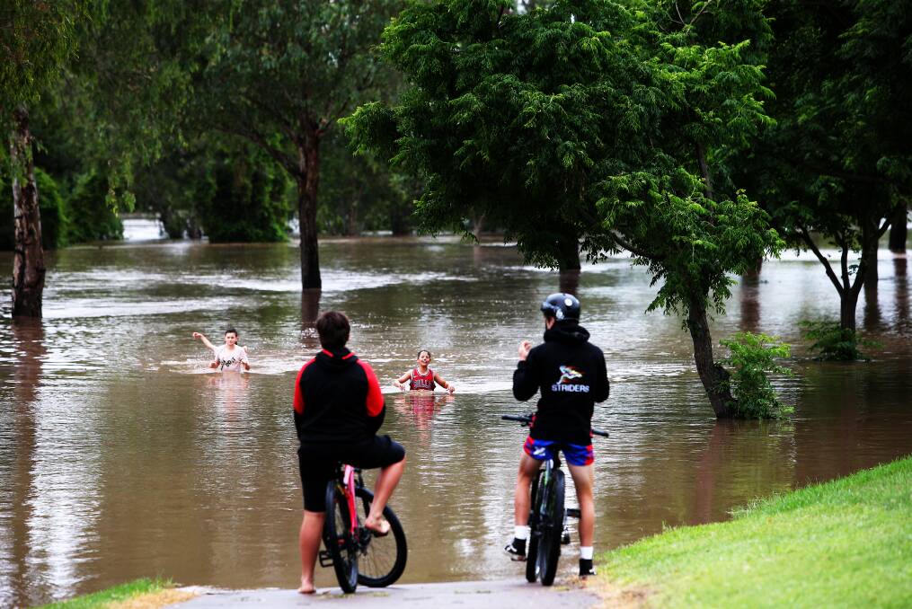 The Hunter River bursts it banks at Singleton, where waters are expected to peak - and potentially exceed major flood levels - into Sunday. Picture: Peter Lorimer