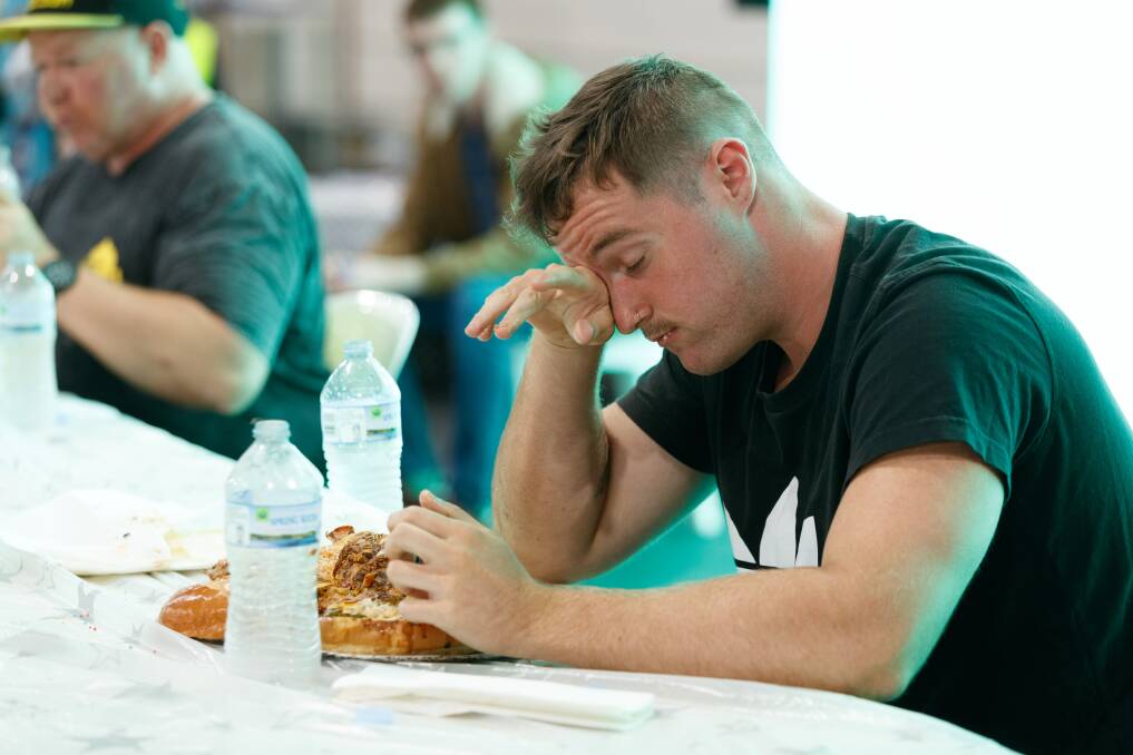 Jake Murnane and his partner Kirra Elliott took on competitive eating machine Jamie 'Lemon Blossom' Miller in a race to finish a massive 2.8kg burger. Picture: Max Mason-Hubers
