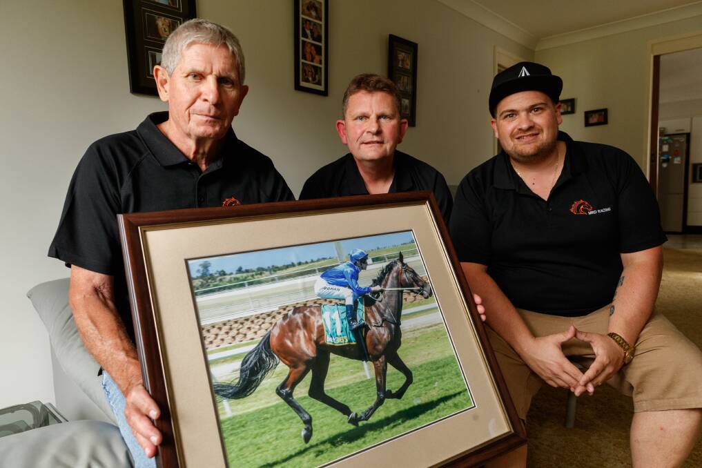 READY TO GO: Mark, Rudi and Daniel Medz with a picture of their Melbourne Cup runner Oceanex at Rudi's home at Barnsley, where they will watch the race from on Tuesday. Picture: Max Mason-Hubers