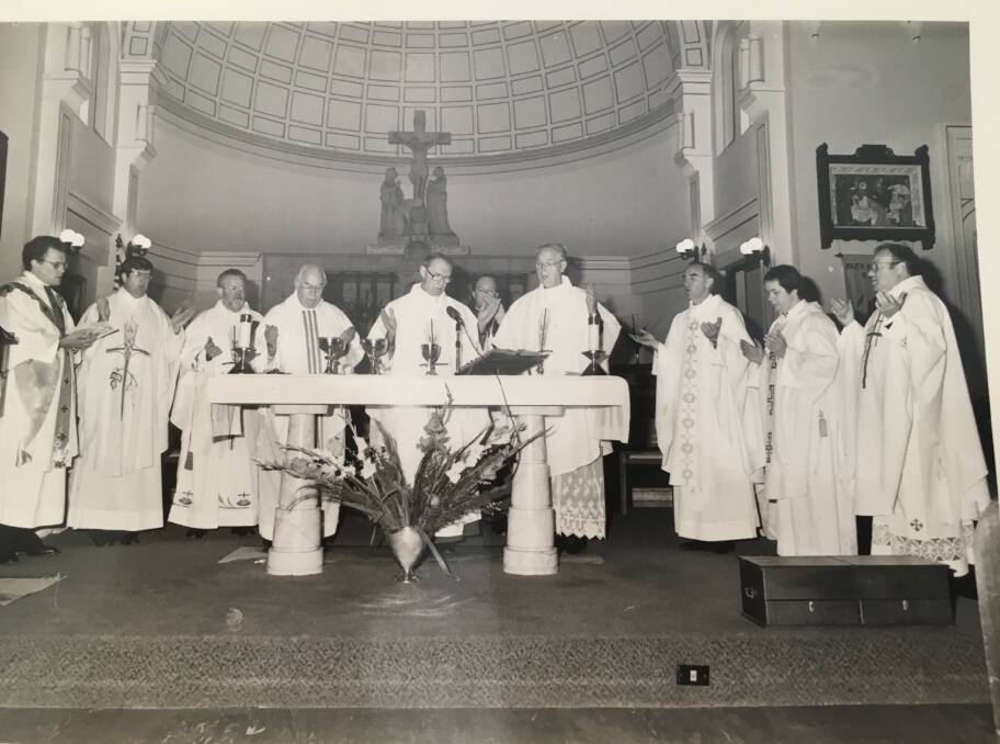 The priest and the power: Bishop Leo Clarke (middle of the altar) giving Mass at Hamilton with priests, including Father Philip Wilson (behind Clarke) and Monsignor Allan Hart, far right in photo.