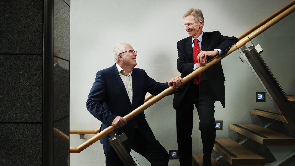 Newcastle Permanent chariman Jeff Eather (left) with Greater Bank chairman Wayne Russell. Picture by Simone De Peak