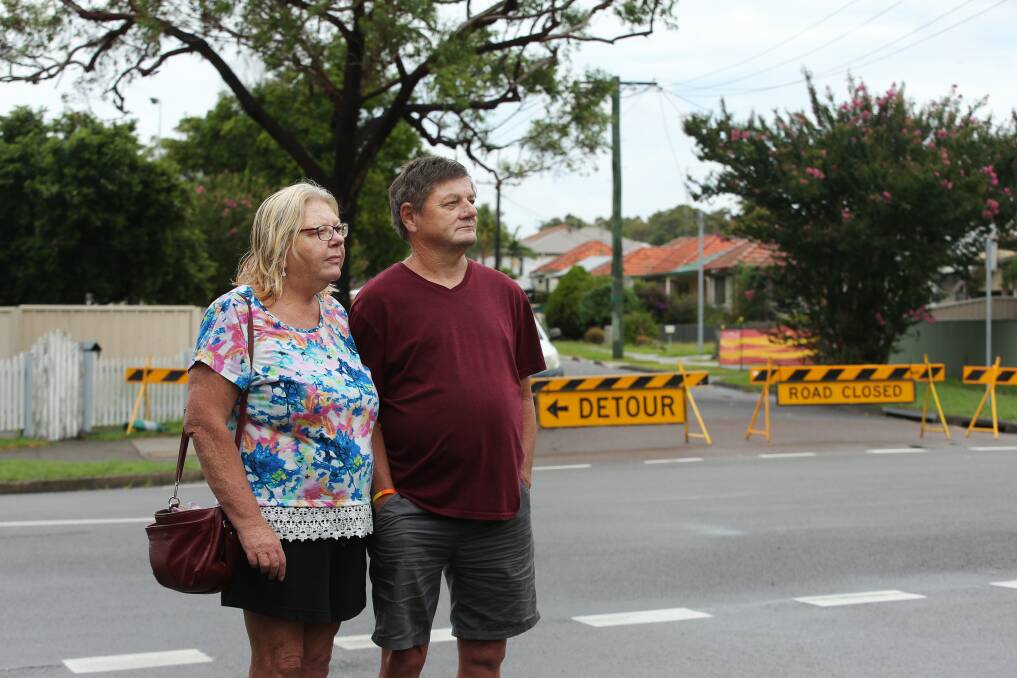 Graham and Catherine Knight of Elemore Vale took in the damage to Fogo Street on Monday. Mr Knight grew up in Wallsend and remembered the booming mining industry that honeycombed the ground beneath the suburb from the Gretley Colliery to the surrounding suburbs. Picture by Simone De Peak