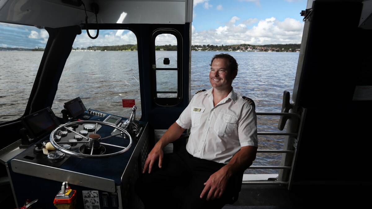 Peter Hanrahan at the helm of the Lake Mac Ferry at Speers Point Jetty. Picture: Simone De Peak
