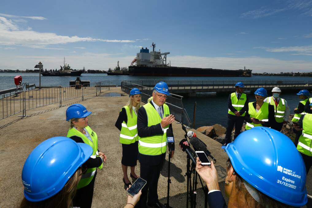POWER PLAY: Prime Minister Scott Morrison in Newcastle on November talking up green hyrdogen as the enormous coal-carrying Empress Zonda heads out of the harbour. Picture: Jonathan Carroll