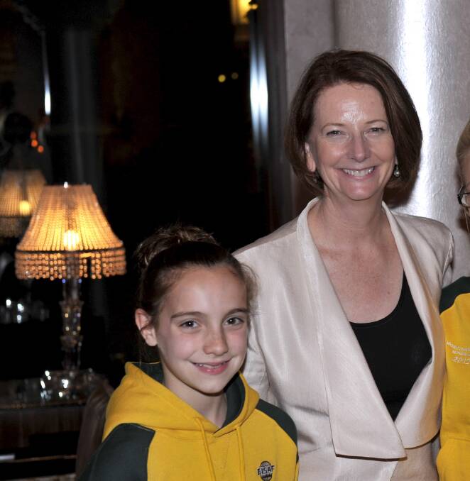 Chance: John Pirona's daughter Siennah, 11, with then Prime Minister Julia Gillard on November 13, 2012 - the day after the child abuse royal commission was announced. The two were photographed after they met by chance in Dubai as Siennah travelled to the Netherlands for a sporting event.   