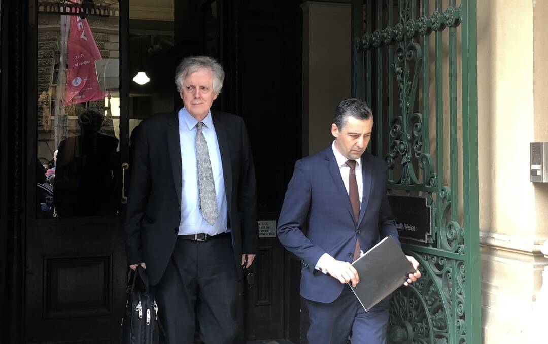 Hearing: Newcastle barrister Robert Cavanagh and solicitor Stuart Gray leave a Sydney court where the first public proceedings in the Folbigg inquiry were held today. 