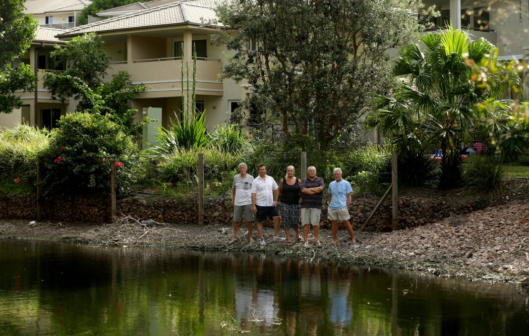 Angry: Nelson Bay Lagoons Estate residents (from left) Bill Park, George Pagacs, Gloria Grayson, Randall Grayson and Roy Johnson are taking Port Stephens Council to court over a decades-old drainage saga. Picture: Jonathan Carroll.
