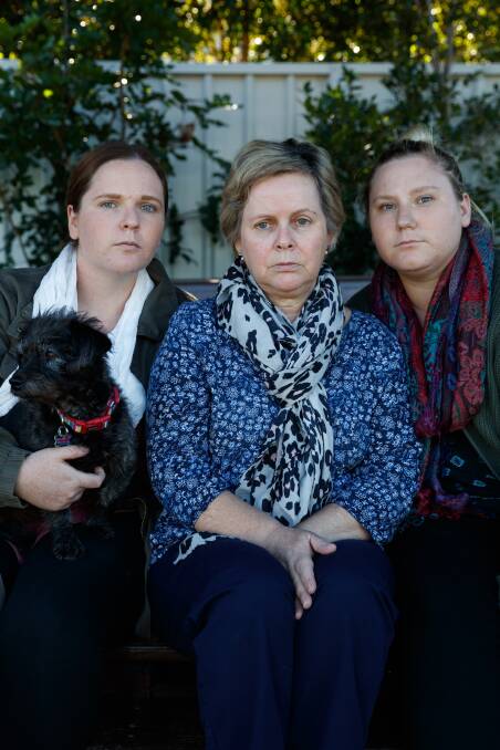 Questions: Sharon Jenkins and daughters Cidney (left) and Kim with family dog Louie. The family was shattered by Tony Jenkins' death. Picture: Max Mason-Hubers.