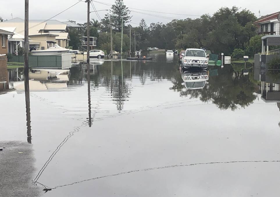 Flood: Houses are stranded at North Entrance as Tuggerah Lakes floodwater rises on Monday.
