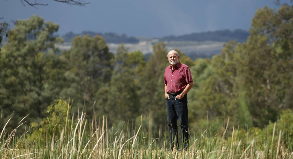 Standards: Bulga resident and community representative on the Upper Hunter's air quality monitoring network, John Krey, with Mount Thorley Warkworth mine in the background. 