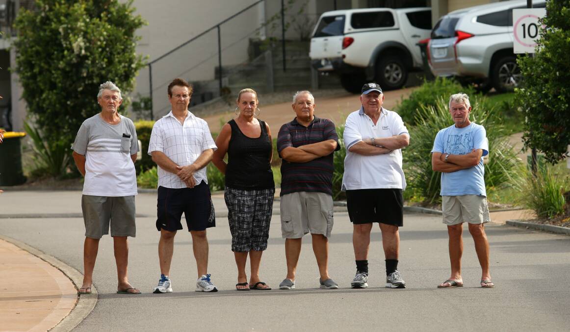 Battle: Nelson Bay Lagoons Estate residents including Ron Ricketts (second from right) are fighting water battles on two fronts over damages and drainage with Port Stephens Council, and a $400,000 water usage bill claim by developer David Vitnell. Picture: Jonathan Carroll. 
