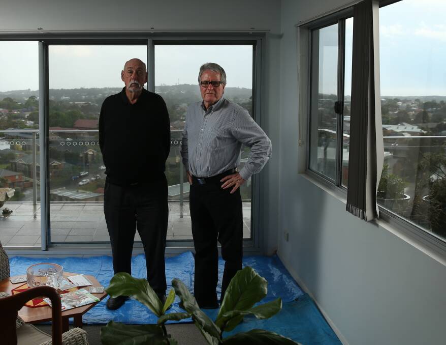 History: Aidan Ellis (right) in his penthouse apartment at the Landmark building in Charlestown with 7th floor unit owner Richard Devon. Both men say NSW governments have failed to address long-standing serious problems in the apartment building industry. 