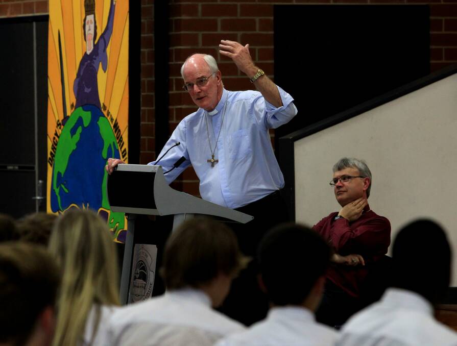 Suspensions: Maitland-Newcastle Catholic Bishop Bill Wright and Newcastle Anglican Bishop Peter Stuart attend a school gathering. Both bishops have suspended church service rituals until further notice in response to the coronavirus threat. Picture: Simone De Peak. 