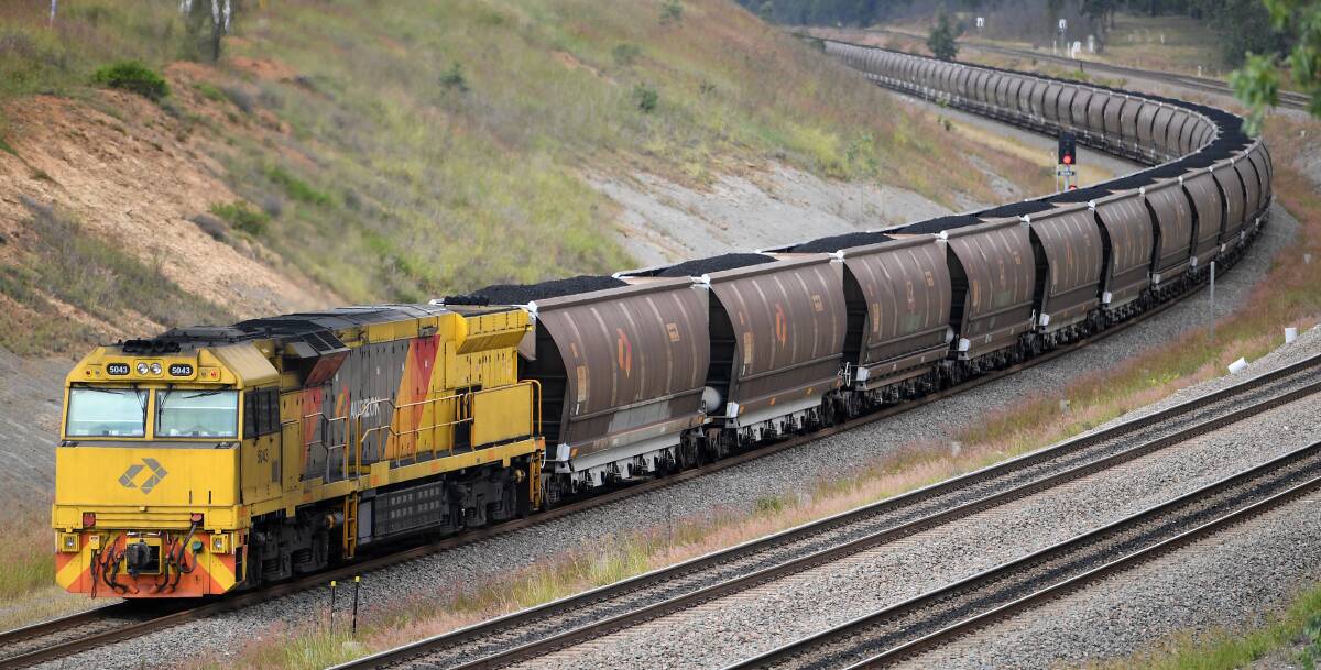 Strategy: A loaded Hunter coal train heads towards one of Newcastle Port's three terminals. The Australian Rail Track Corporation is proposing to roll out new systems that would increase capacity, in response to mining indutry complaints, despite figures showing coal exports peaking in 2023. 