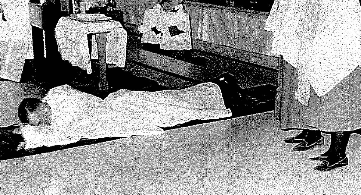 Prostrated: Clarence Anderson prostrates himself during the ordination ceremony in 1963 before becoming a priest.