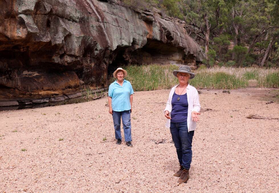 Dry: Environment campaigners Bev Smiles and Julia Imrie in a section of the Goulburn River where water flow into the river is controlled by Ulan mine discharges. 