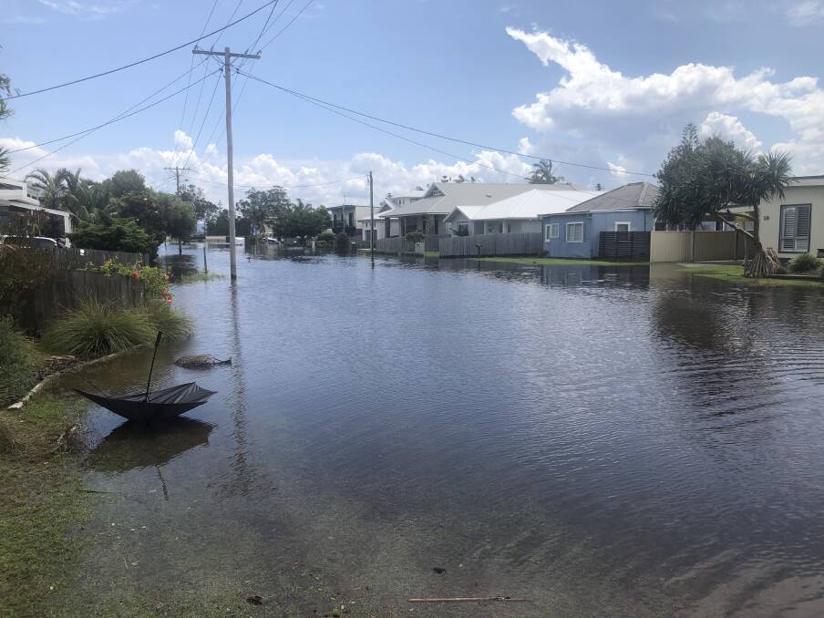 Overwhelmed: A swollen Tuggerah Lakes after weekend downfalls turned this suburban North Entrance street into a lake extension by Wednesday morning. 