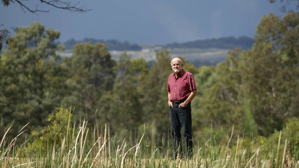 Committee: Bulga resident John Krey stands on his property with Mount Thorley Warkworth open cut coal mine in the background.